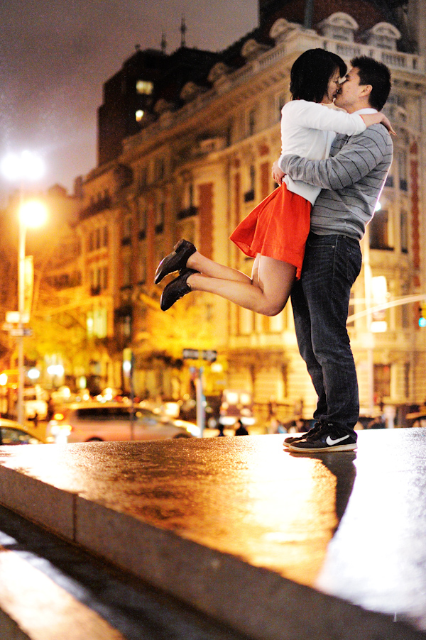 couple in mid kiss while groom sweeps bride off her feet in a giant hug